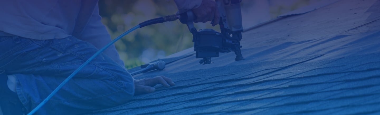 Mills Roofing employee repairs roof
