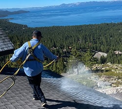 Mills Roofing employee applies Roof Maxx
